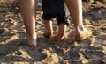 Close up image father and son legs walk at the seaside Royalty Free Stock Photo