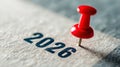 Red Pushpin on Paper with Year 2026 Highlighted for Event Planning or Reminder Purpose Royalty Free Stock Photo
