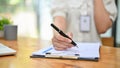 Close-up image of a female accountant examining financial report at her table Royalty Free Stock Photo