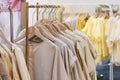 Female cotton clothes in neutral colors tone hanging on clothing rack for sale in boutique fashion store Royalty Free Stock Photo