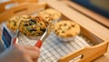 Close-up, A female customer buying a wholewheat muffin with raisins in pastry shop