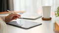 Close-up image of a female freelance graphic designer working on her project on tablet Royalty Free Stock Photo