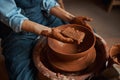 Unrecognized ceramicist in apron working with fresh wet clay i pottery workshop Royalty Free Stock Photo