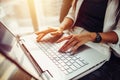 Close-up image of female hands on keyboard. Woman working on laptop