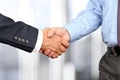 Close-up image of a firm handshake between two colleagues in off