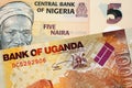 A five Nigerian Naira bank note with a thousand Ugandan shilling bill