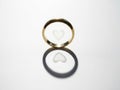 Golden wedding band with heart design casts reflective shadow Royalty Free Stock Photo