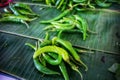 Close-up image of green peppers placed on banana leaves in Asian markets, food markets