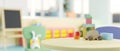 A close-up image of a green round table features kids\' toys in a colorful kindergarten classroom Royalty Free Stock Photo