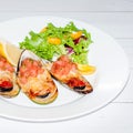 Close-up image grilled clam mussel and cheese with salad and lemon