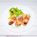 Close-up image grilled clam mussel and cheese with salad and lemon