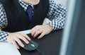 Close-up image of a hand of a little boy working at a computer.