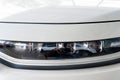 Close-up image of headlights of white modern car Royalty Free Stock Photo