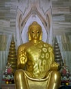 Close up image of Huge golden statue of sitting Buddha outside Thai temple in Sarnath near Varanasi