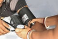 Close up image of an Indian female doctor checking blood pressure of patient at home Royalty Free Stock Photo