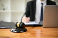 Close-up image of a judge gavel or judge hammer is on a wooden desk in a lawyer office Royalty Free Stock Photo