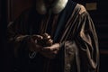 Close-up image of a judge holding a wooden gavel. closeup of a judge wearing a law robe, AI Generated