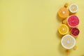 Close up image of juicy organic assorted sliced citrus fruits, visible core texture, bright paper textured background, copy space Royalty Free Stock Photo