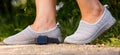 Close up image of the legs of woman in comfortable shoes for jogging outdoors and digital watch lies on the ground. Royalty Free Stock Photo