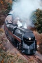 Close-up image of a locomotive engine traveling down a railroad track