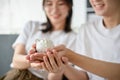 Close-up image of a lovely young Asian couple holding a small, cute piggy bank together Royalty Free Stock Photo