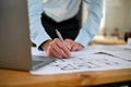 Close-up image of a male engineer checking scale and building plan design on a blueprint Royalty Free Stock Photo