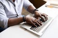 Close up image of male hands with accessories typing text on the laptop keyboard Royalty Free Stock Photo