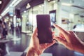 Close-up image of male hands using smartphone. Blurred background