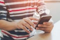 Close-up image of male hands using smartphone with icon telephone email mobile phone and address