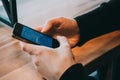 Close-up image of male hands using smartphone at night on city shopping street, searching or social networks concept Royalty Free Stock Photo