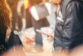 Close-up image of male hands using smartphone at night on city shopping street, searching or social networks concept, hipster man Royalty Free Stock Photo