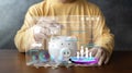 Close-up image of man hand putting coins in pink piggy bank for account save money. Planning step up, saving money for future plan Royalty Free Stock Photo