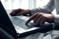 Close up image of man hands typing on laptop computer keyboard ,  surfing the internet or online working . business and technology Royalty Free Stock Photo