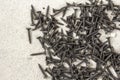 Close-up image of many small black screws on concrete background Royalty Free Stock Photo