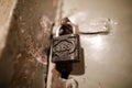 Close up image with a metallic old and rust lock on the door of a communist Romania Securitate prison cell