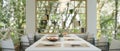 Close-up image of a modern and cozy dining room with a large dining table and beautiful nature view Royalty Free Stock Photo