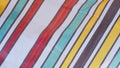 Multi colored stripes on plastic canvas surface in diagonal view