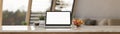 Notebook laptop mockup on marble tabletop over blurred living room in the background