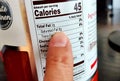 Close-up shot of a Nutrition label with finger pointing to the Total Saturated Fats