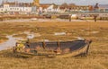 Close up image of an old abandoned row boat on the saltmarsh at Shoreham by Sea estuary