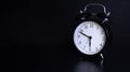 Close up image of old black vintage alarm clock. 10 minutes before six o`clock Royalty Free Stock Photo