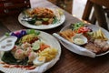 Close-up image of Pad Thai, fresh shrimp, Thai food, pork steak and rice noodles, water on a wooden table Royalty Free Stock Photo