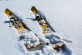 Close up image of pair old fashioned wooden yellow skis on the white snow