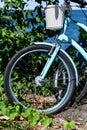 Close-up image of white bicycle front wheel tire and basket on the handle bar Royalty Free Stock Photo