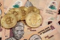 Close up of Bitcoins with Nigerian naira