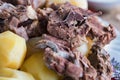 Boiled lamb meat and whole potatoes close up