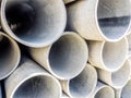 Close up image of pile grey steel pipes at the construction site. Industrial concept