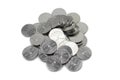 A pile of silver five halala coins from Saudi Arabia on a white background