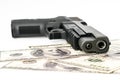 Close up image of pistol and dollar .