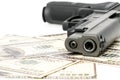 Close up image of pistol and dollar .